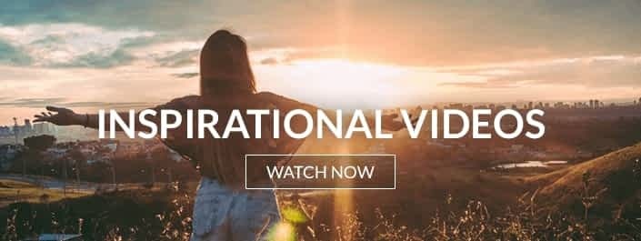 image of a woman with arms wide open, basking in the warmth of a sunrise