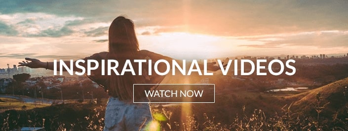 image of a woman with arms wide open, basking in the warmth of a sunrise